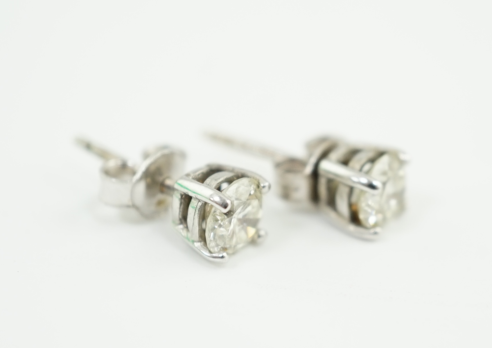 A pair of 18k white gold and solitaire diamond set ear studs